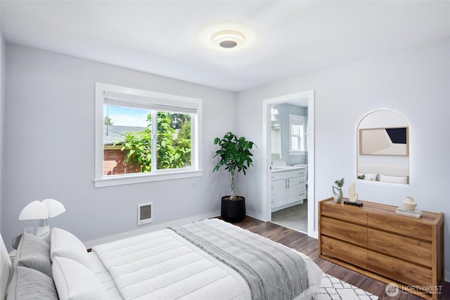 9348 54th Ave S, Seattle, WA 98118 - bedroom featuring wood finished floors, connected bathroom, and baseboards