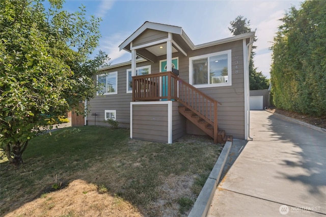 9348 54th Ave S, Seattle, WA 98118 - view of front of house with a front lawn, a garage, and concrete driveway