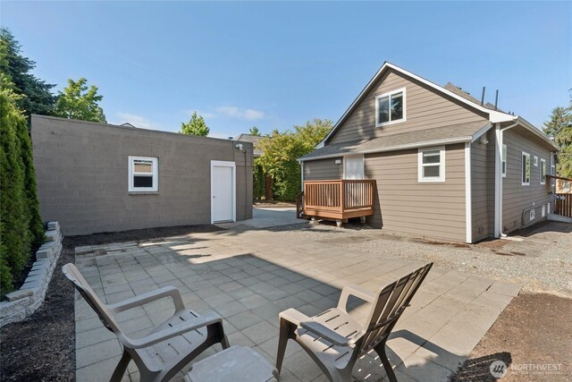 9348 54th Ave S, Seattle, WA 98118 - rear view of property with a patio area and a wooden deck