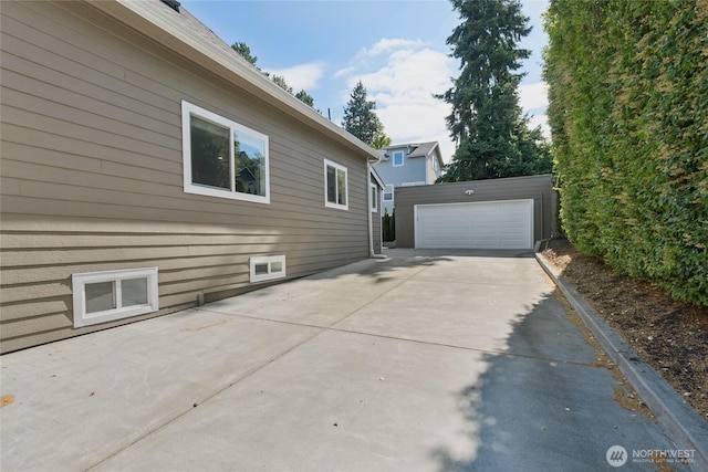 9348 54th Ave S, Seattle, WA 98118 - view of property exterior featuring an outdoor structure and a garage