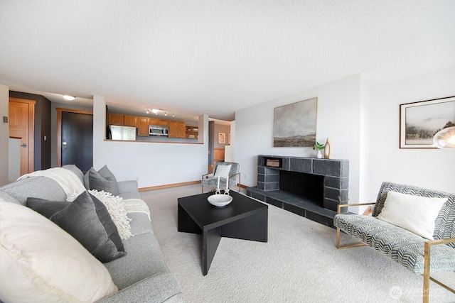 carpeted living area with a tile fireplace