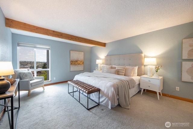 bedroom with beam ceiling, carpet floors, baseboards, and a textured ceiling
