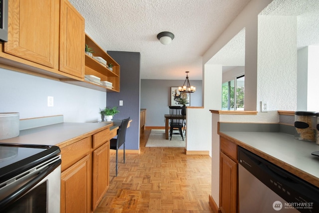 kitchen featuring stainless steel appliances, a textured ceiling, light countertops, a chandelier, and open shelves