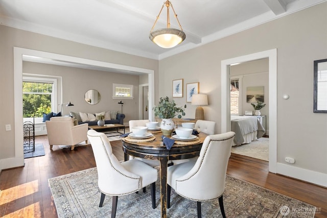 dining area with wood finished floors, ornamental molding, and baseboards