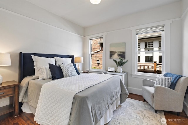 bedroom with wood finished floors and baseboards