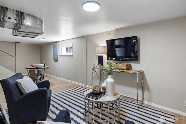 living area featuring wood finished floors and baseboards