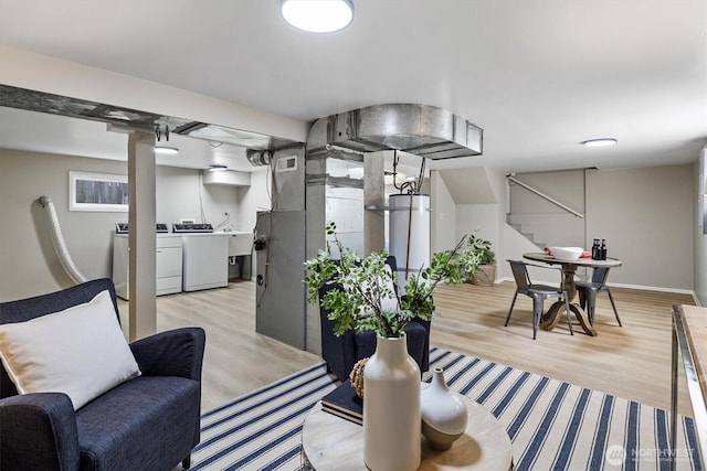 interior space featuring independent washer and dryer, stairway, and a sink