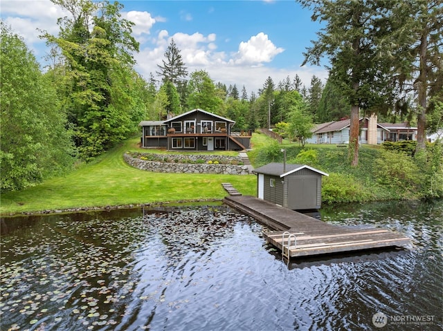 dock featuring a lawn and a deck with water view