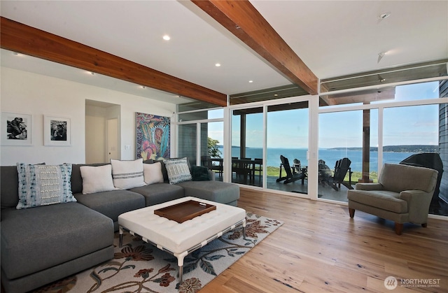 3139 Saratoga Rd, Langley, WA 98260 - living room with beam ceiling, a water view, healthy amount of natural light, a wall of windows, and wood finished floors