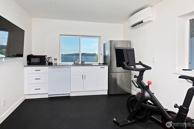 3139 Saratoga Rd, Langley, WA 98260 - exercise area featuring a sink, a wall mounted AC, and baseboards