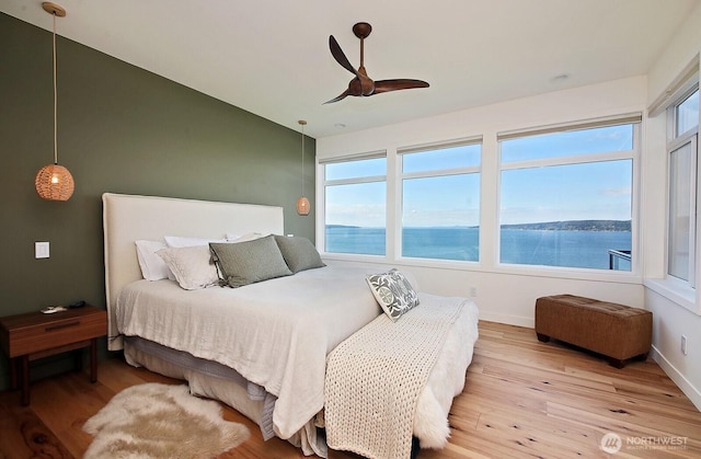 3139 Saratoga Rd, Langley, WA 98260 - bedroom with light wood-style flooring, a water view, baseboards, and ceiling fan