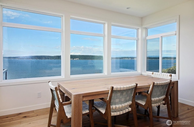 3139 Saratoga Rd, Langley, WA 98260 - dining area with baseboards, light wood-style flooring, healthy amount of natural light, and a water view