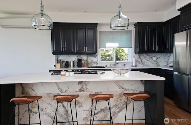 3139 Saratoga Rd, Langley, WA 98260 - kitchen with stainless steel appliances, a sink, dark cabinets, backsplash, and a wall unit AC