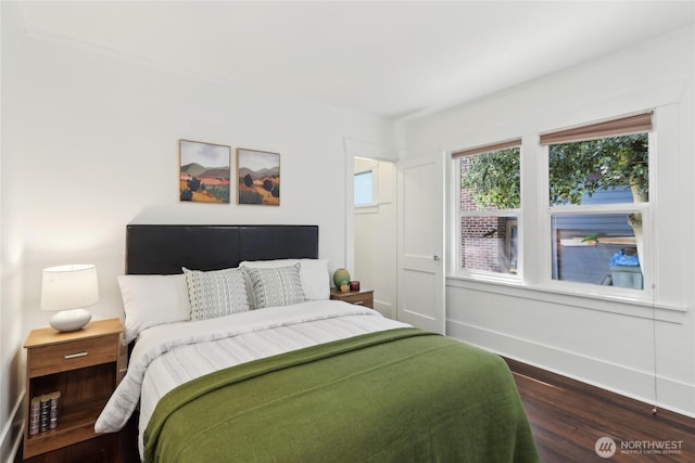 bedroom featuring dark wood-type flooring and baseboards