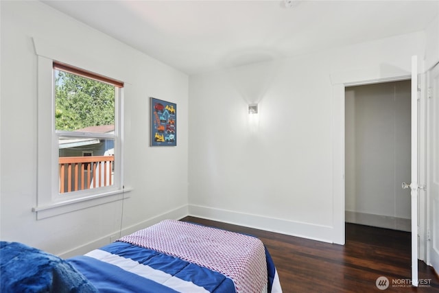 bedroom with wood finished floors and baseboards