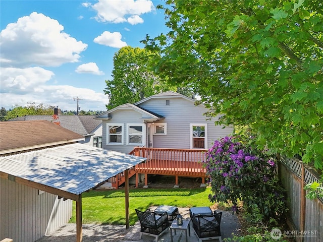 rear view of property with a deck and a patio area