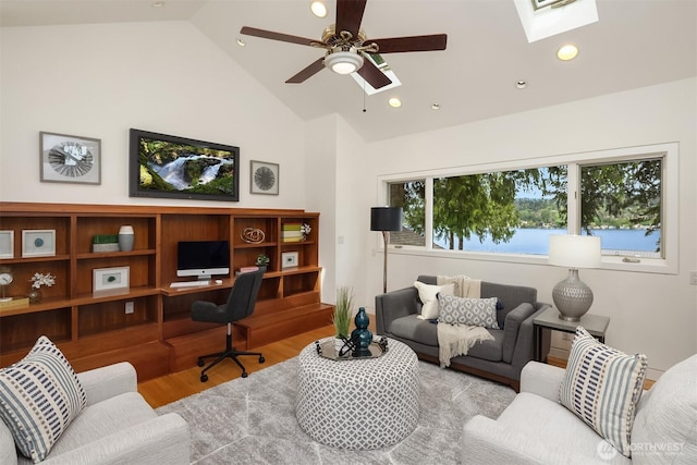 office featuring a skylight, wood finished floors, high vaulted ceiling, ceiling fan, and recessed lighting