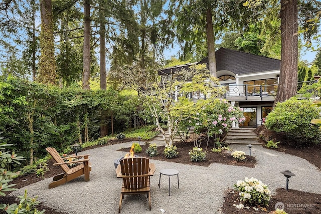 rear view of house featuring a fire pit