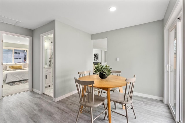 dining room with light wood-type flooring, baseboards, and recessed lighting