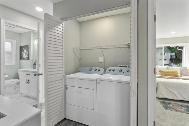 laundry room featuring washer and dryer and recessed lighting