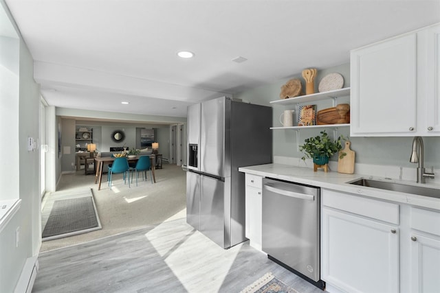 kitchen featuring stainless steel appliances, white cabinetry, open shelves, a sink, and recessed lighting