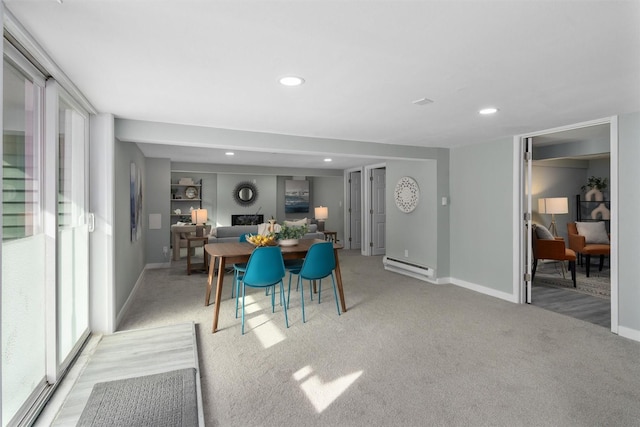 dining space with baseboard heating, light carpet, baseboards, and recessed lighting
