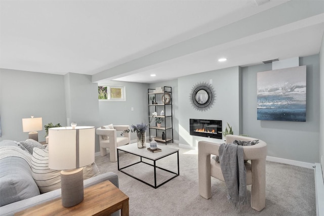 living area with carpet floors, a glass covered fireplace, baseboards, and recessed lighting