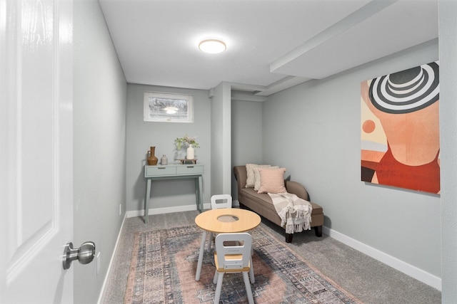 sitting room featuring baseboards and carpet