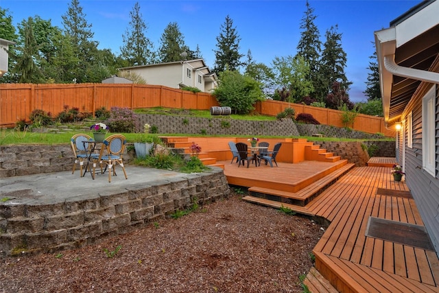 deck featuring a fenced backyard, a patio, and outdoor dining space