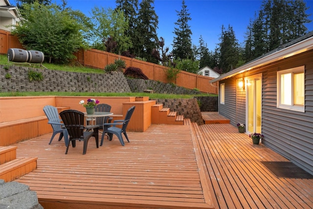 wooden deck featuring a fenced backyard and outdoor dining area