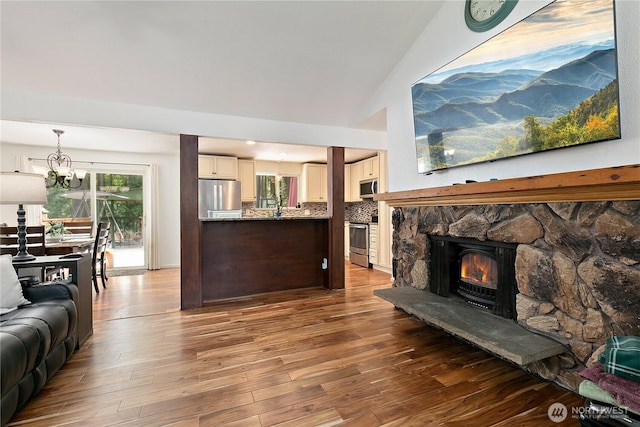 4909 95th Ave W, University Place, WA 98467 - living room featuring a chandelier, wood finished floors, and lofted ceiling