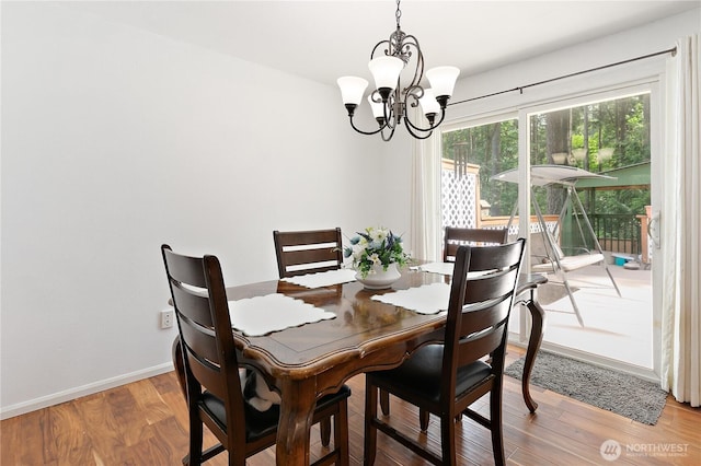 4909 95th Ave W, University Place, WA 98467 - dining area with a chandelier, light wood-style flooring, and baseboards