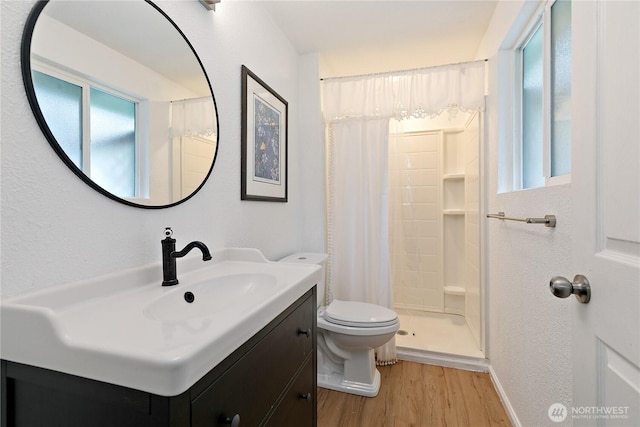 4909 95th Ave W, University Place, WA 98467 - full bath with wood finished floors, a shower stall, toilet, and vanity