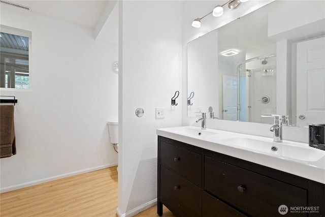 4909 95th Ave W, University Place, WA 98467 - full bath featuring wood finished floors, a shower stall, baseboards, and double vanity