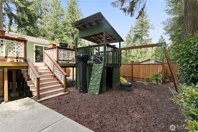 4909 95th Ave W, University Place, WA 98467 - view of jungle gym with fence, stairway, and a deck
