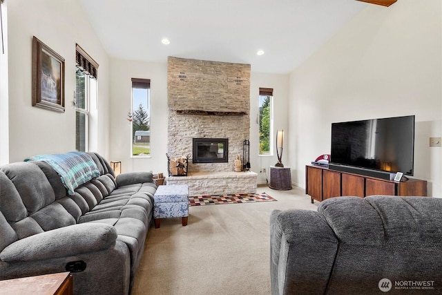 living room featuring healthy amount of natural light, carpet, lofted ceiling, a fireplace, and recessed lighting
