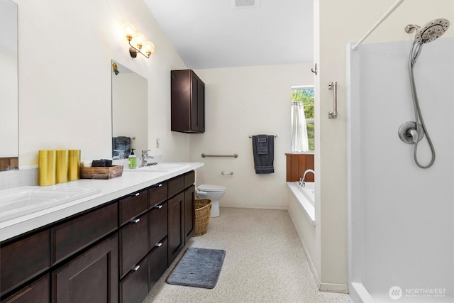 bathroom featuring toilet, double vanity, speckled floor, a bath, and a shower