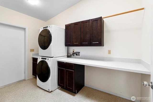 washroom with cabinet space and estacked washer and dryer