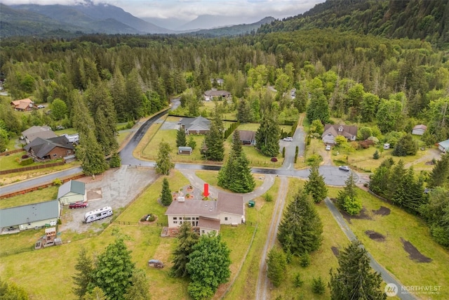 aerial view of a heavily wooded area and mountains