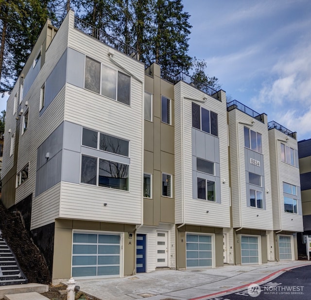 8826 NE 173rd Pl Unit C, Bothell, WA 98011 - view of apartment building / complex with a garage and driveway
