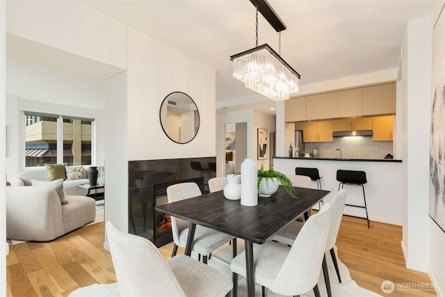 2721 1st Ave Unit 407, Seattle, WA 98121 - dining area featuring a chandelier and light wood finished floors