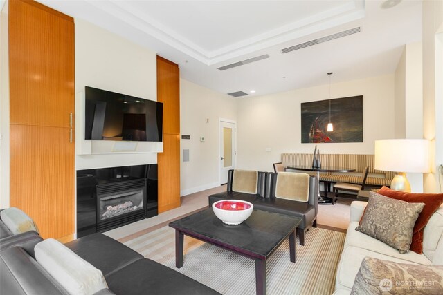 2721 1st Ave Unit 407, Seattle, WA 98121 - living room featuring a raised ceiling and a fireplace with flush hearth