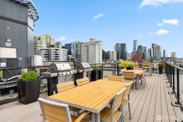 2721 1st Ave Unit 407, Seattle, WA 98121 - deck with outdoor dining area, a view of skyline, and area for grilling