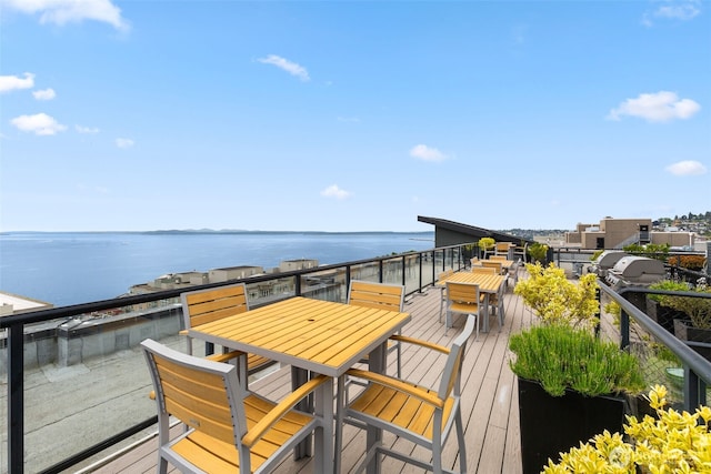 2721 1st Ave Unit 407, Seattle, WA 98121 - wooden terrace with a water view and outdoor dining space