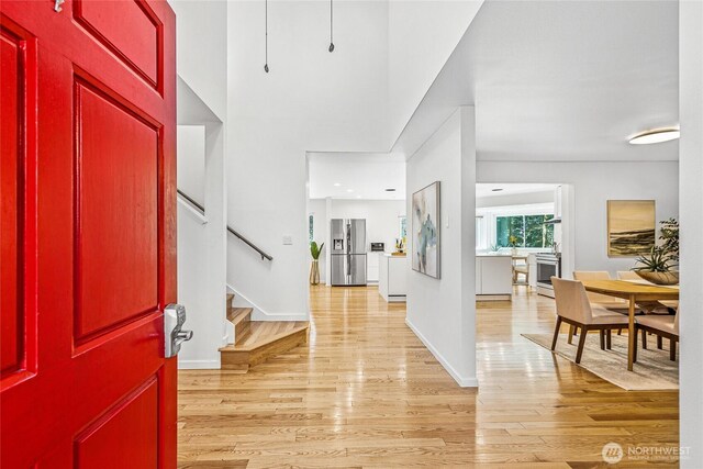 27923 NE 49th St, Redmond, WA 98053 - foyer featuring light wood-type flooring, stairs, and baseboards