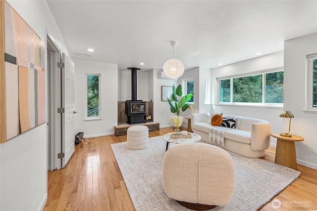 27923 NE 49th St, Redmond, WA 98053 - living area with a wood stove, light wood finished floors, baseboards, and recessed lighting