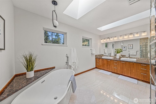 27923 NE 49th St, Redmond, WA 98053 - bathroom with a skylight, double vanity, a freestanding bath, and baseboards