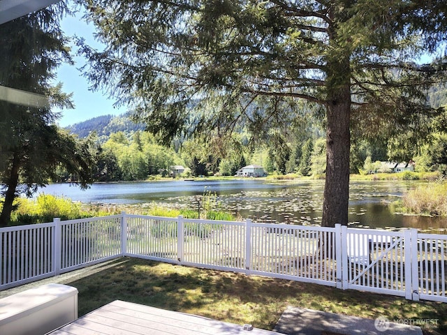 659 Cain Lake Rd, Sedro Woolley, WA 98284 - wooden deck with a water view and a fenced backyard