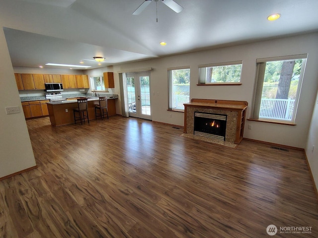 659 Cain Lake Rd, Sedro Woolley, WA 98284 - living room with dark wood-style flooring, a fireplace with flush hearth, french doors, recessed lighting, and baseboards