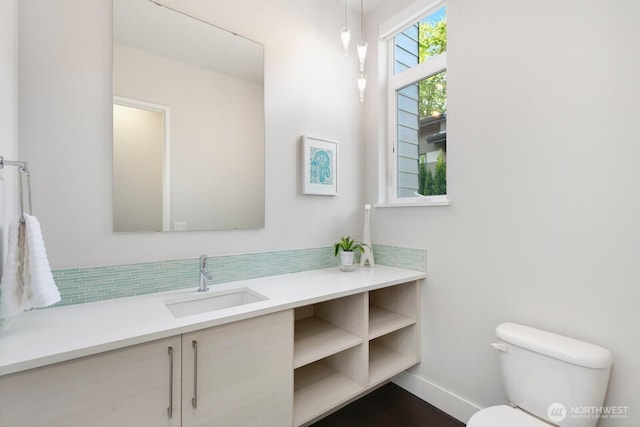 21955 SE 30th Pl, Sammamish, WA 98075 - bathroom featuring toilet, vanity, baseboards, and tasteful backsplash